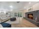Spacious living area with a cozy fireplace, modern furnishings, and sliding doors to outdoor space at 102 Linda Ln, Lake Mary, FL 32746
