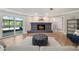 Inviting living room with a cozy fireplace, stylish decor, and access to the outdoor patio at 102 Linda Ln, Lake Mary, FL 32746