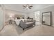 Relaxing main bedroom boasts a sitting area, ceiling fan, carpeted floor, and ensuite bathroom at 102 Linda Ln, Lake Mary, FL 32746