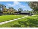 Lovely backyard featuring a brick path, luscious green grass, and two homes at 10209 Trout Rd, Orlando, FL 32836
