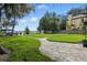 Beautiful backyard featuring green grass, a brick path, and water access at 10209 Trout Rd, Orlando, FL 32836