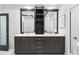 Modern bathroom featuring dual sinks, vanity with drawers, and dark wood accents at 10209 Trout Rd, Orlando, FL 32836