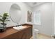 Chic powder room with unique sink, sleek vanity, oval mirror, and stylish glass-block window at 10209 Trout Rd, Orlando, FL 32836