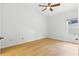 Bedroom showcasing light-colored wood flooring, ceiling fan, and a bright window at 10209 Trout Rd, Orlando, FL 32836