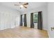 Bright bedroom with light wood flooring, closet, and natural light from the windows at 10209 Trout Rd, Orlando, FL 32836