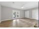 Serene bedroom with hardwood floors, neutral walls, ceiling fan, and door leading to the backyard patio at 10209 Trout Rd, Orlando, FL 32836