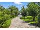 Beautiful brick driveway leads to a serene home, surrounded by lush greenery and mature trees at 10209 Trout Rd, Orlando, FL 32836