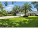 Home exterior with lush lawn, brick paved drive, basketball hoop and an attached garage at 10209 Trout Rd, Orlando, FL 32836