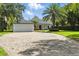 Spacious home with a paved driveway, well-manicured lawn, and attached two-car garage at 10209 Trout Rd, Orlando, FL 32836