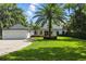 Charming single-story home with lush landscaping, brick driveway, and a spacious two-car garage at 10209 Trout Rd, Orlando, FL 32836