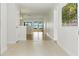 Bright hallway with tile transitioning to wood flooring, leading to a living space with expansive water views at 10209 Trout Rd, Orlando, FL 32836