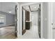 Hallway leads to a living area and wet bar featuring glass doors and white tile flooring at 10209 Trout Rd, Orlando, FL 32836
