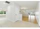 Bright hallway with tile transitioning to wood flooring, leading to a living space with expansive water views at 10209 Trout Rd, Orlando, FL 32836