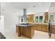 Spacious kitchen boasts stainless appliances, stone countertops, kitchen island and stylish tile backsplash at 10209 Trout Rd, Orlando, FL 32836