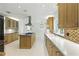 Bright, open kitchen featuring custom cabinetry, stainless appliances, granite countertops, and kitchen island at 10209 Trout Rd, Orlando, FL 32836