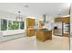 Bright kitchen featuring stainless steel appliances, custom cabinets, a center island, and a window seat at 10209 Trout Rd, Orlando, FL 32836