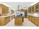 Spacious kitchen with custom wood cabinets, granite counters, stainless steel appliances, and center island at 10209 Trout Rd, Orlando, FL 32836