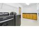 Spacious laundry room with modern washer and dryer, ample counter space and overhead storage at 10209 Trout Rd, Orlando, FL 32836