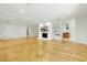 Spacious living room with hardwood floors, white walls, fireplace with a large television screen at 10209 Trout Rd, Orlando, FL 32836