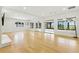 Bright, open-plan living room with hardwood floors and plenty of windows overlooking a scenic view at 10209 Trout Rd, Orlando, FL 32836