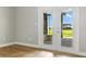 Bright living room features French doors with water views and light wood floors at 10209 Trout Rd, Orlando, FL 32836