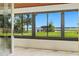 Large windows offer a clear view of the water and dock outside this home at 10209 Trout Rd, Orlando, FL 32836
