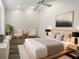 Spacious bedroom with a king bed, ceiling fan, and modern decor at 109 Greentree Ln, Yalaha, FL 34797