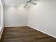 Empty bedroom with hardwood floors, a ceiling fan, neutral paint, and natural light at 109 Greentree Ln, Yalaha, FL 34797