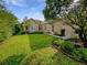 Inviting front yard showcasing a lush green lawn and beautiful landscaping around the home at 109 Greentree Ln, Yalaha, FL 34797