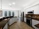Modern kitchen featuring stainless steel appliances, a breakfast bar, and tile flooring at 109 Greentree Ln, Yalaha, FL 34797