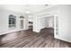 Bright living room with hardwood floors, bright windows, and glass french doors at 109 Greentree Ln, Yalaha, FL 34797