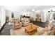 Open-concept living room featuring hardwood floors and a stylish kitchen with a breakfast bar at 109 Greentree Ln, Yalaha, FL 34797