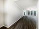 Bright living room showcasing dark hardwood floors and arched windows at 109 Greentree Ln, Yalaha, FL 34797