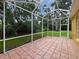 A screened patio area with brick-style flooring at 109 Greentree Ln, Yalaha, FL 34797