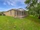 Rear exterior view of the home showing screened lanai at 109 Greentree Ln, Yalaha, FL 34797