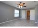 The bedroom featuring tile floors, with an attached bathroom and closet at 1131 S Pine Ridge Cir # 1, Sanford, FL 32773