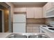 Kitchen with white cabinets and appliances, and gray countertops at 1131 S Pine Ridge Cir # 1, Sanford, FL 32773