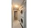 A well lit laundry room area featuring a stacked washer and dryer and tile floors at 1131 S Pine Ridge Cir # 1, Sanford, FL 32773
