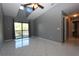 Living room with high ceilings, fan, gray walls, and sliding door to balcony at 1131 S Pine Ridge Cir # 1, Sanford, FL 32773