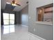 Living room with gray walls, tiled floors, open kitchen view, and balcony at 1131 S Pine Ridge Cir # 1, Sanford, FL 32773