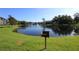 Scenic pond with a fountain, surrounded by trees and green grass with grill at 1131 S Pine Ridge Cir # 1, Sanford, FL 32773