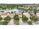 Aerial view of homes along a lake, showcasing the tile roofs and serene community setting at 12286 Regal Lily Ln, Orlando, FL 32827