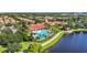 Aerial view showcasing a community pool and outdoor social areas and a large lake at 12286 Regal Lily Ln, Orlando, FL 32827