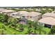 Spacious backyard with manicured landscaping, palm trees, and a screened-in patio area at 12286 Regal Lily Ln, Orlando, FL 32827