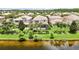 Beautiful backyard with a tranquil water view, lush landscaping, and mature palm trees at 12286 Regal Lily Ln, Orlando, FL 32827