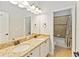 Bathroom featuring double sinks, granite countertops, and separate toilet area at 12286 Regal Lily Ln, Orlando, FL 32827