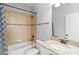 Bathroom with tile shower and granite countertop sink, and blue shower curtain at 12286 Regal Lily Ln, Orlando, FL 32827