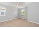 Bright bedroom featuring carpeted floors and natural light from the window at 12286 Regal Lily Ln, Orlando, FL 32827