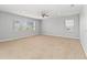 Bright and airy bedroom featuring neutral carpet, ceiling fan and large windows for natural light at 12286 Regal Lily Ln, Orlando, FL 32827