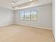 Bedroom with carpet, ceiling fan and a large window at 12286 Regal Lily Ln, Orlando, FL 32827